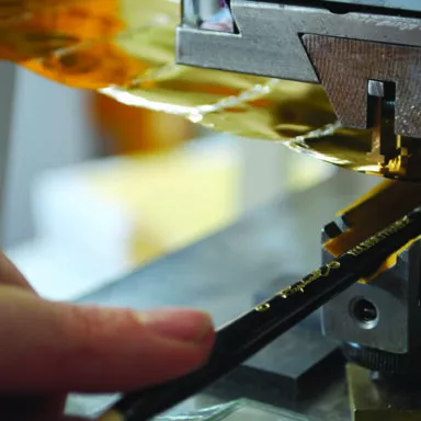 Close-up of gold hot stamping process marking brand name on a brush handle