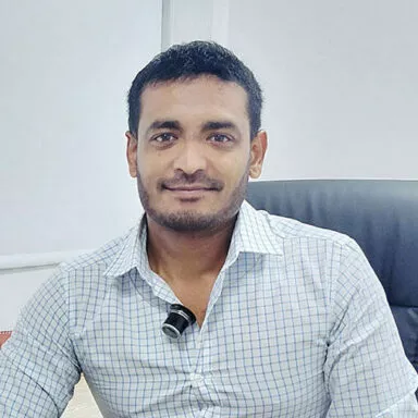 Portrait of production manager Ruben at his desk in an office environment
